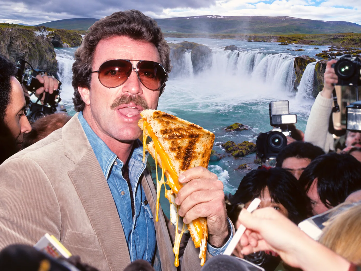 Grilled cheese — Selleck faces reporters with a grilled-cheese microphone in front of Godafoss.